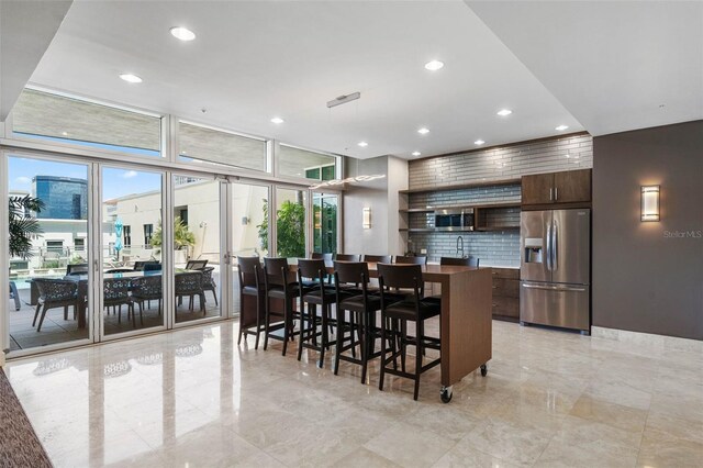 400 4th Ave S Unit 508, Saint Petersburg, FL 33701 - dining area featuring recessed lighting, light marble finish floors, and expansive windows