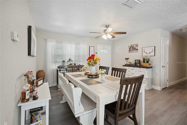 811 Patricia Pl, Lakeland, FL 33809 - dining room featuring light wood finished floors, a ceiling fan, a textured ceiling, and baseboards