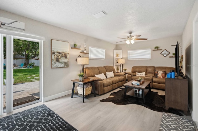 811 Patricia Pl, Lakeland, FL 33809 - living area with wood finished floors, a ceiling fan, a textured ceiling, and baseboards
