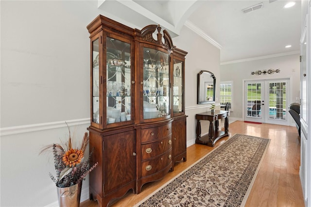 9830 Caribou Trl, Dade City, FL 33525 - hallway featuring french doors, light wood-type flooring, ornamental molding, baseboards, and recessed lighting