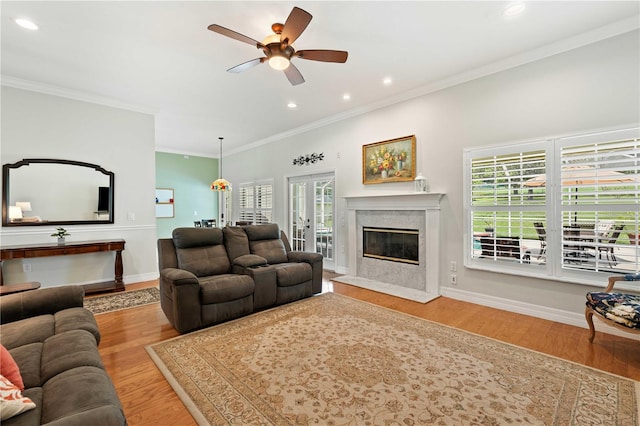 9830 Caribou Trl, Dade City, FL 33525 - living room with ceiling fan, a high end fireplace, wood finished floors, recessed lighting, and crown molding