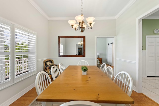9830 Caribou Trl, Dade City, FL 33525 - dining room featuring a chandelier, crown molding, a barn door, and light tile patterned floors