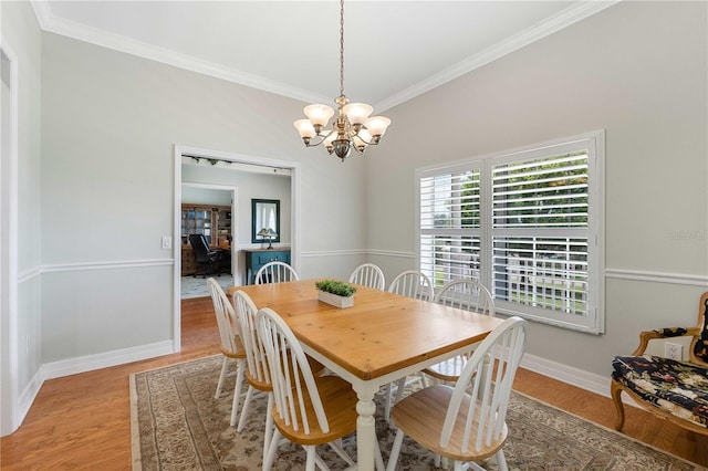 9830 Caribou Trl, Dade City, FL 33525 - dining space featuring crown molding, a chandelier, baseboards, and light wood finished floors