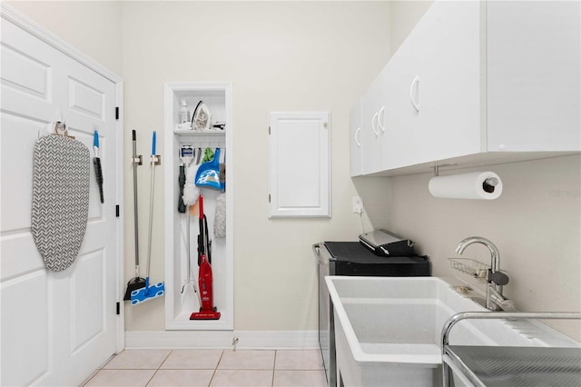 9830 Caribou Trl, Dade City, FL 33525 - laundry area with light tile patterned floors, baseboards, and washer / clothes dryer