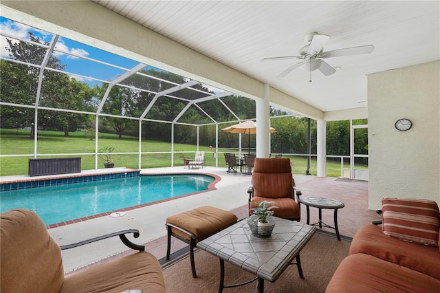 9830 Caribou Trl, Dade City, FL 33525 - swimming pool featuring a patio area, a ceiling fan, a lawn, and a lanai