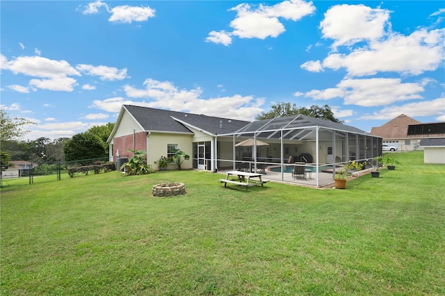 9830 Caribou Trl, Dade City, FL 33525 - back of house featuring a fire pit, a patio area, glass enclosure, and an outdoor pool
