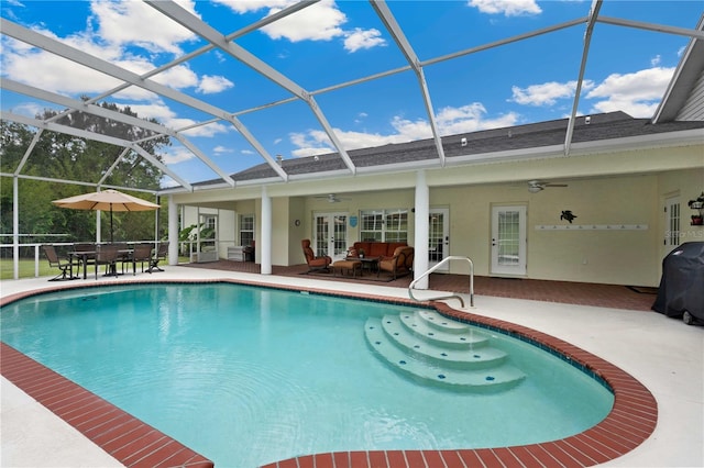 9830 Caribou Trl, Dade City, FL 33525 - swimming pool with a ceiling fan, french doors, a patio, outdoor lounge area, and glass enclosure