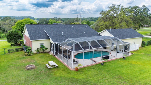 9830 Caribou Trl, Dade City, FL 33525 - rear view of house with a patio, an outdoor fire pit, an outdoor pool, roof with shingles, and stucco siding