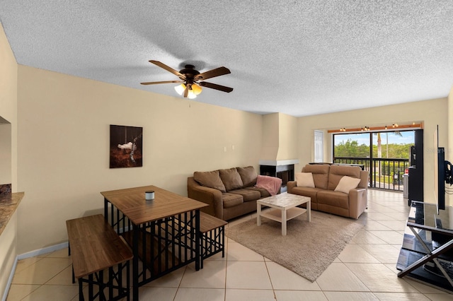 1905 Oyster Catcher Ln Unit 924, Clearwater, FL 33762 - living area with ceiling fan, a textured ceiling, light tile patterned flooring, and baseboards