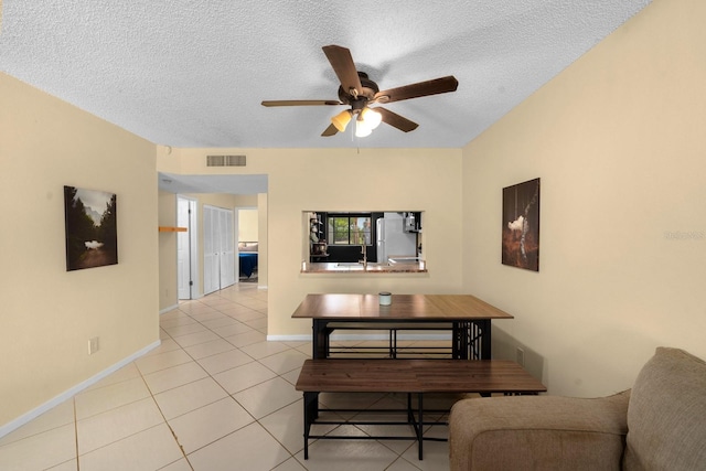 1905 Oyster Catcher Ln Unit 924, Clearwater, FL 33762 - dining area with a ceiling fan, a textured ceiling, light tile patterned flooring, and baseboards