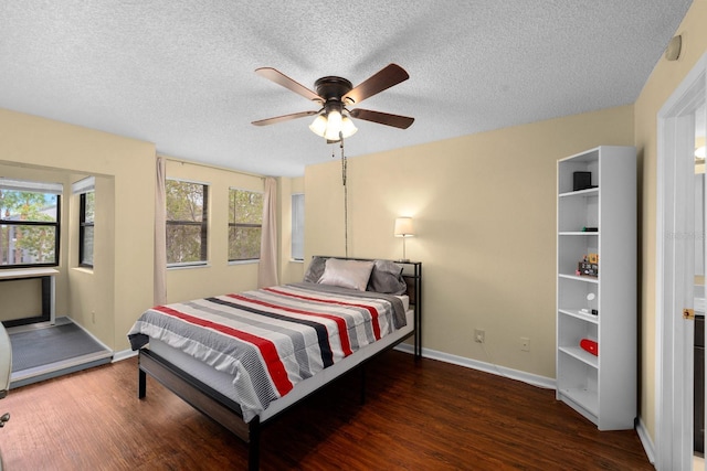 1905 Oyster Catcher Ln Unit 924, Clearwater, FL 33762 - bedroom featuring wood finished floors, baseboards, a textured ceiling, and a ceiling fan