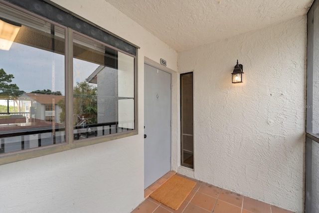 1905 Oyster Catcher Ln Unit 924, Clearwater, FL 33762 - view of exterior entry with stucco siding and a balcony