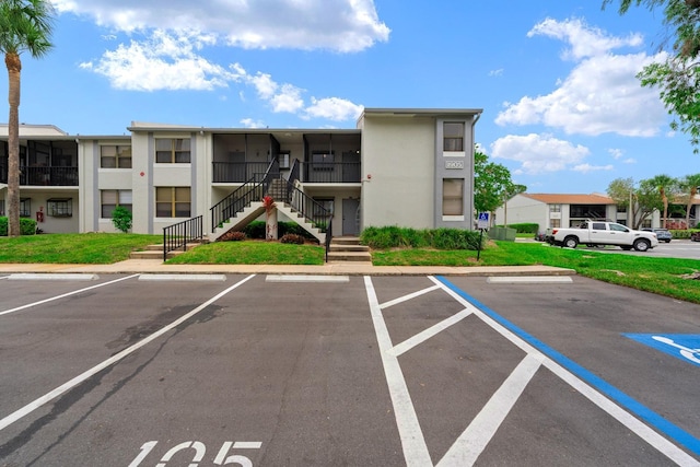 1905 Oyster Catcher Ln Unit 924, Clearwater, FL 33762 - view of building exterior with stairway, uncovered parking, and a residential view