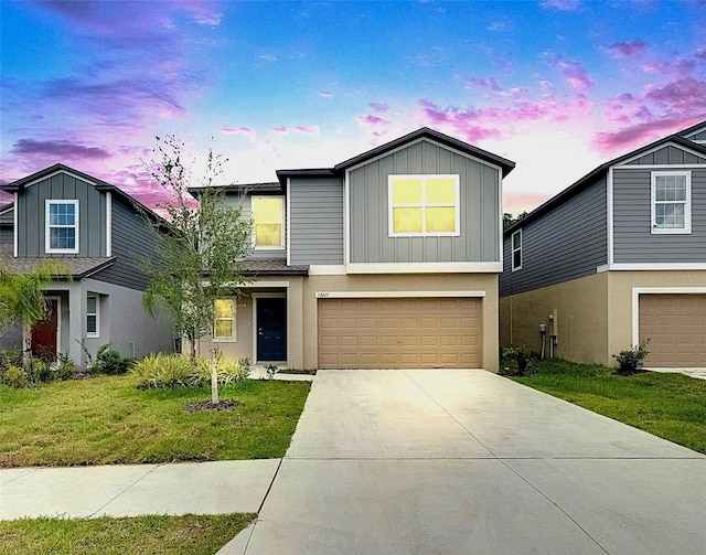 12617 Maple Bonsai Dr, Riverview, FL 33579 - view of front of house with a garage, board and batten siding, driveway, stucco siding, and a front lawn