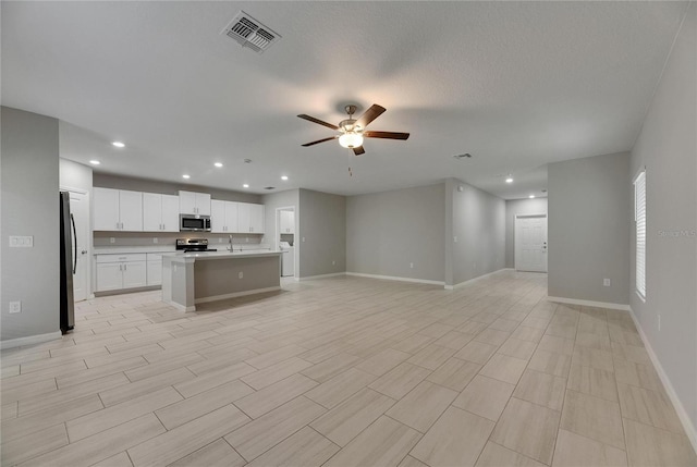 12617 Maple Bonsai Dr, Riverview, FL 33579 - kitchen with appliances with stainless steel finishes, open floor plan, ceiling fan, recessed lighting, and baseboards