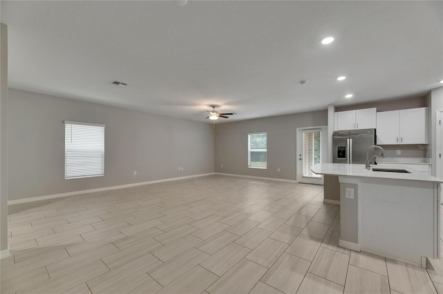 12617 Maple Bonsai Dr, Riverview, FL 33579 - kitchen with stainless steel fridge, a sink, light countertops, ceiling fan, and open floor plan