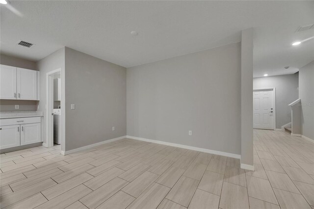 12617 Maple Bonsai Dr, Riverview, FL 33579 - unfurnished living room with recessed lighting, baseboards, stairway, wood finish floors, and washer / dryer