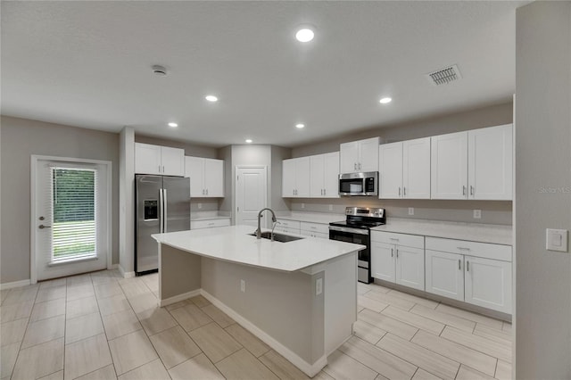 12617 Maple Bonsai Dr, Riverview, FL 33579 - kitchen with stainless steel appliances, a sink, light countertops, white cabinetry, and recessed lighting
