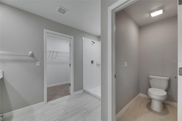 12617 Maple Bonsai Dr, Riverview, FL 33579 - bathroom with a shower stall, toilet, a walk in closet, and baseboards