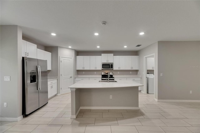12617 Maple Bonsai Dr, Riverview, FL 33579 - kitchen featuring stainless steel appliances, washer / dryer, light countertops, recessed lighting, and a sink