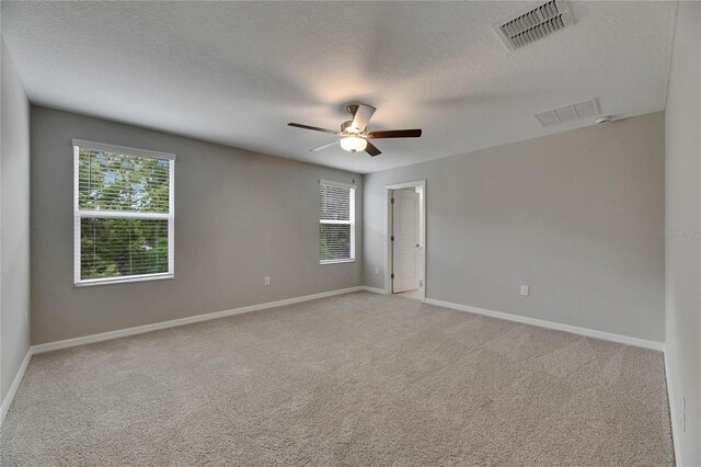 12617 Maple Bonsai Dr, Riverview, FL 33579 - unfurnished room featuring a ceiling fan, light carpet, baseboards, and a textured ceiling