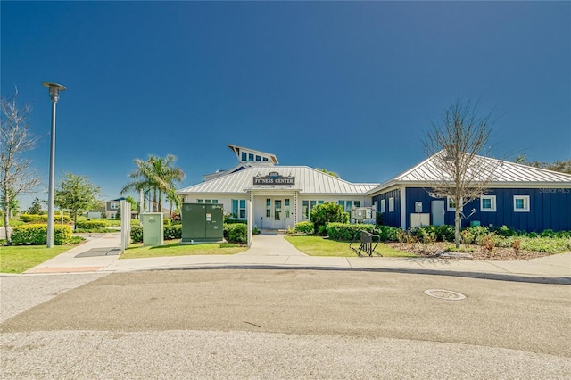 12617 Maple Bonsai Dr, Riverview, FL 33579 - view of front facade with board and batten siding, metal roof, and a standing seam roof