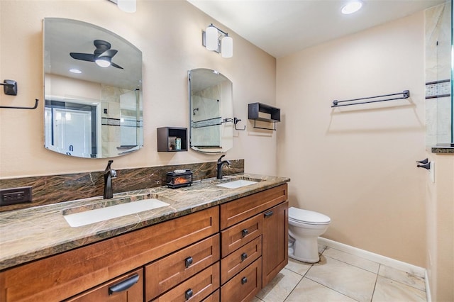 10954 96th St, Largo, FL 33773 - bathroom with toilet, double vanity, a shower, tile patterned flooring, and a ceiling fan