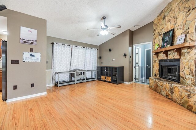 10954 96th St, Largo, FL 33773 - unfurnished living room featuring ceiling fan, lofted ceiling, wood finished floors, a textured ceiling, and baseboards