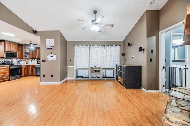 10954 96th St, Largo, FL 33773 - unfurnished living room featuring a ceiling fan, light wood-style floors, baseboards, and a textured ceiling
