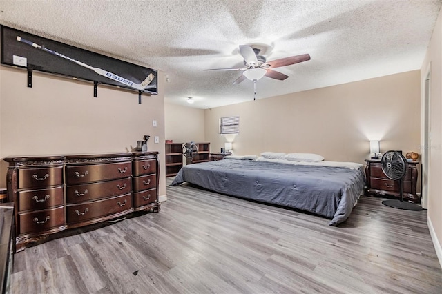 10954 96th St, Largo, FL 33773 - bedroom with wood finished floors, a textured ceiling, a ceiling fan, and baseboards