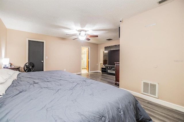 10954 96th St, Largo, FL 33773 - bedroom with wood finished floors, baseboards, a textured ceiling, and ceiling fan