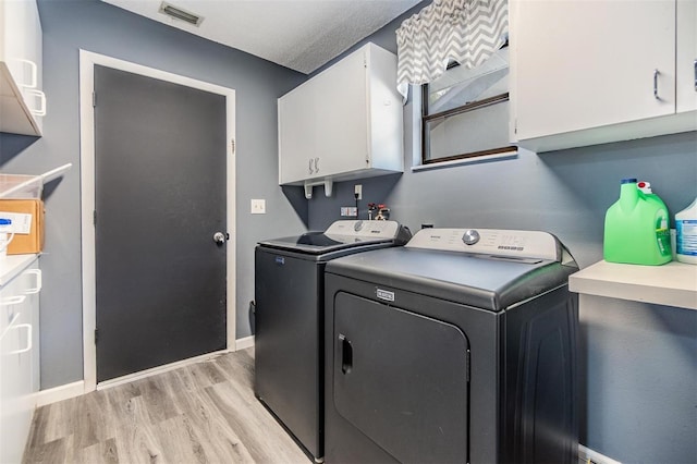 10954 96th St, Largo, FL 33773 - laundry area with cabinet space, washer and dryer, light wood-style floors, and baseboards