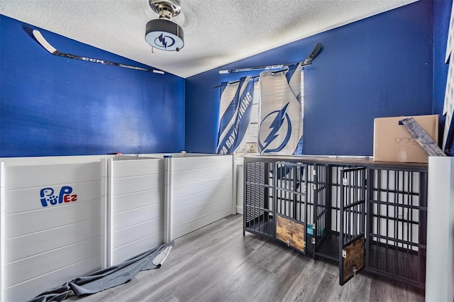 10954 96th St, Largo, FL 33773 - misc room featuring wood finished floors and a textured ceiling