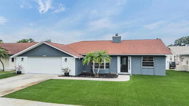 10954 96th St, Largo, FL 33773 - view of front of property with a front lawn, stucco siding, a chimney, a garage, and driveway