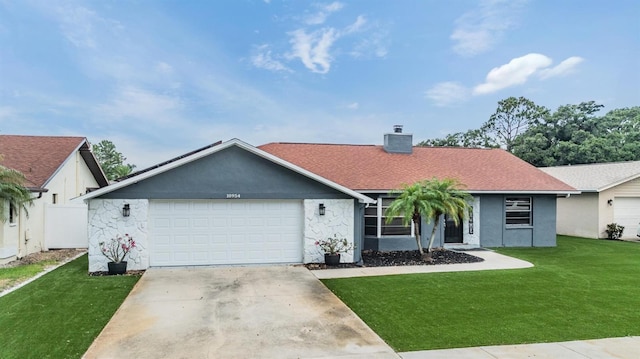 10954 96th St, Largo, FL 33773 - ranch-style house featuring a chimney, a front yard, an attached garage, concrete driveway, and stucco siding
