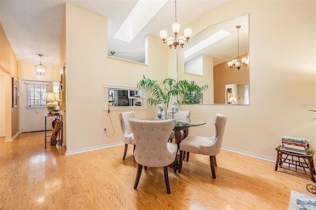 13205 Cypress Hill Dr, Hudson, FL 34669 - dining space with a chandelier, wood finished floors, baseboards, and vaulted ceiling
