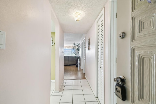 17920 Gulf Blvd Unit 208, Redington Shores, FL 33708 - hall featuring a textured ceiling and light tile patterned flooring