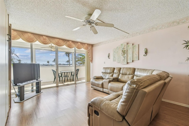 17920 Gulf Blvd Unit 208, Redington Shores, FL 33708 - living area with a textured ceiling, ceiling fan, and wood finished floors