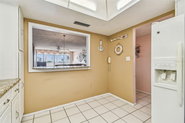 17920 Gulf Blvd Unit 208, Redington Shores, FL 33708 - unfurnished dining area with a chandelier, baseboards, and light tile patterned floors