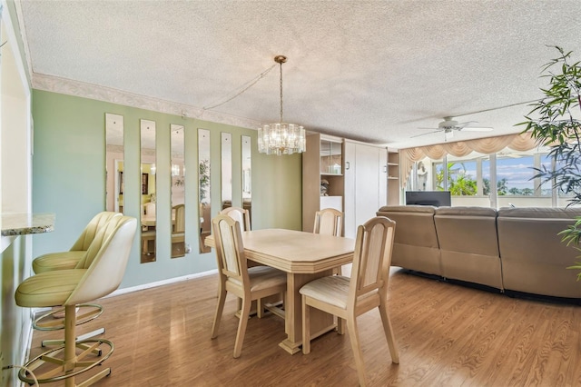 17920 Gulf Blvd Unit 208, Redington Shores, FL 33708 - dining area featuring a textured ceiling, ceiling fan, light wood-style flooring, a chandelier, and baseboards