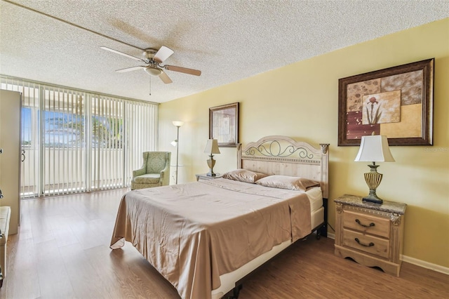 17920 Gulf Blvd Unit 208, Redington Shores, FL 33708 - bedroom with wood finished floors, access to exterior, a textured ceiling, baseboards, and ceiling fan