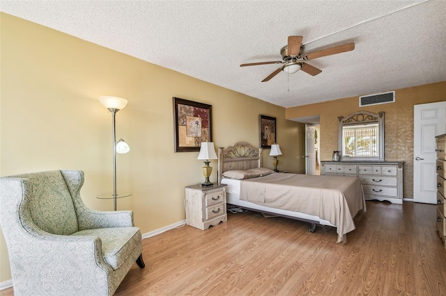 17920 Gulf Blvd Unit 208, Redington Shores, FL 33708 - bedroom with a textured ceiling, wood finished floors, baseboards, and a ceiling fan