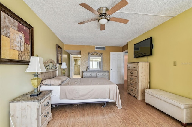 17920 Gulf Blvd Unit 208, Redington Shores, FL 33708 - bedroom with a textured ceiling, light wood finished floors, and a ceiling fan