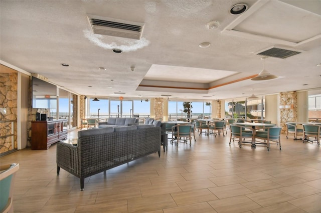 17920 Gulf Blvd Unit 208, Redington Shores, FL 33708 - building lobby featuring a wall of windows and a textured ceiling