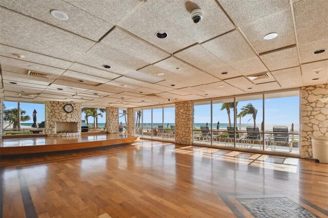 17920 Gulf Blvd Unit 208, Redington Shores, FL 33708 - unfurnished living room with wood finished floors, a water view, healthy amount of natural light, and expansive windows