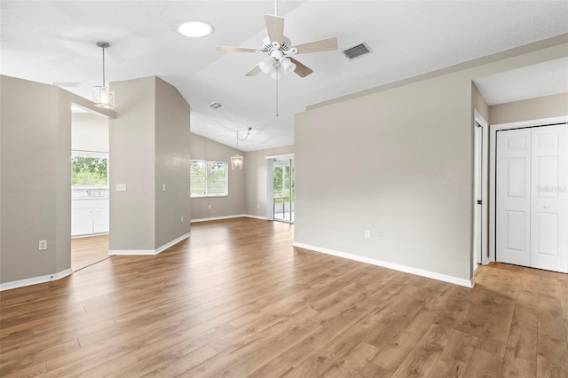 8175 Sturbridge Unit 8175, Weeki Wachee, FL 34613 - unfurnished room featuring a ceiling fan, plenty of natural light, light wood-style floors, and vaulted ceiling