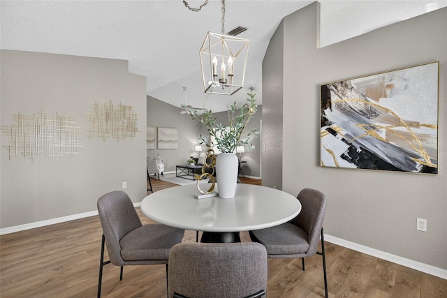 8175 Sturbridge Unit 8175, Weeki Wachee, FL 34613 - dining area featuring wood finished floors, a chandelier, and lofted ceiling