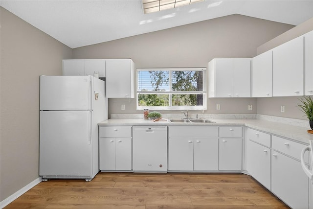 8175 Sturbridge Unit 8175, Weeki Wachee, FL 34613 - kitchen featuring white appliances, light countertops, white cabinetry, light wood-type flooring, and high vaulted ceiling