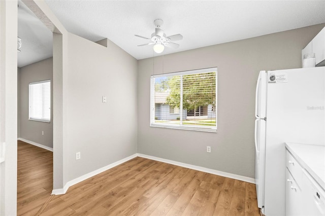 8175 Sturbridge Unit 8175, Weeki Wachee, FL 34613 - unfurnished dining area with plenty of natural light, ceiling fan, and light wood finished floors