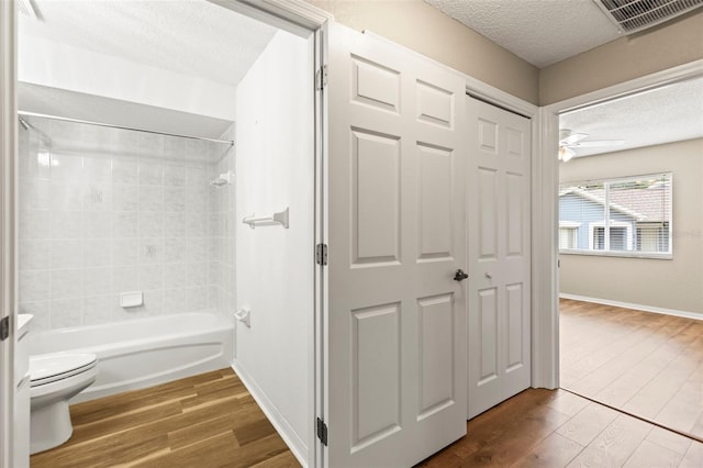 8175 Sturbridge Unit 8175, Weeki Wachee, FL 34613 - full bathroom with wood finished floors, a textured ceiling, washtub / shower combination, and a ceiling fan